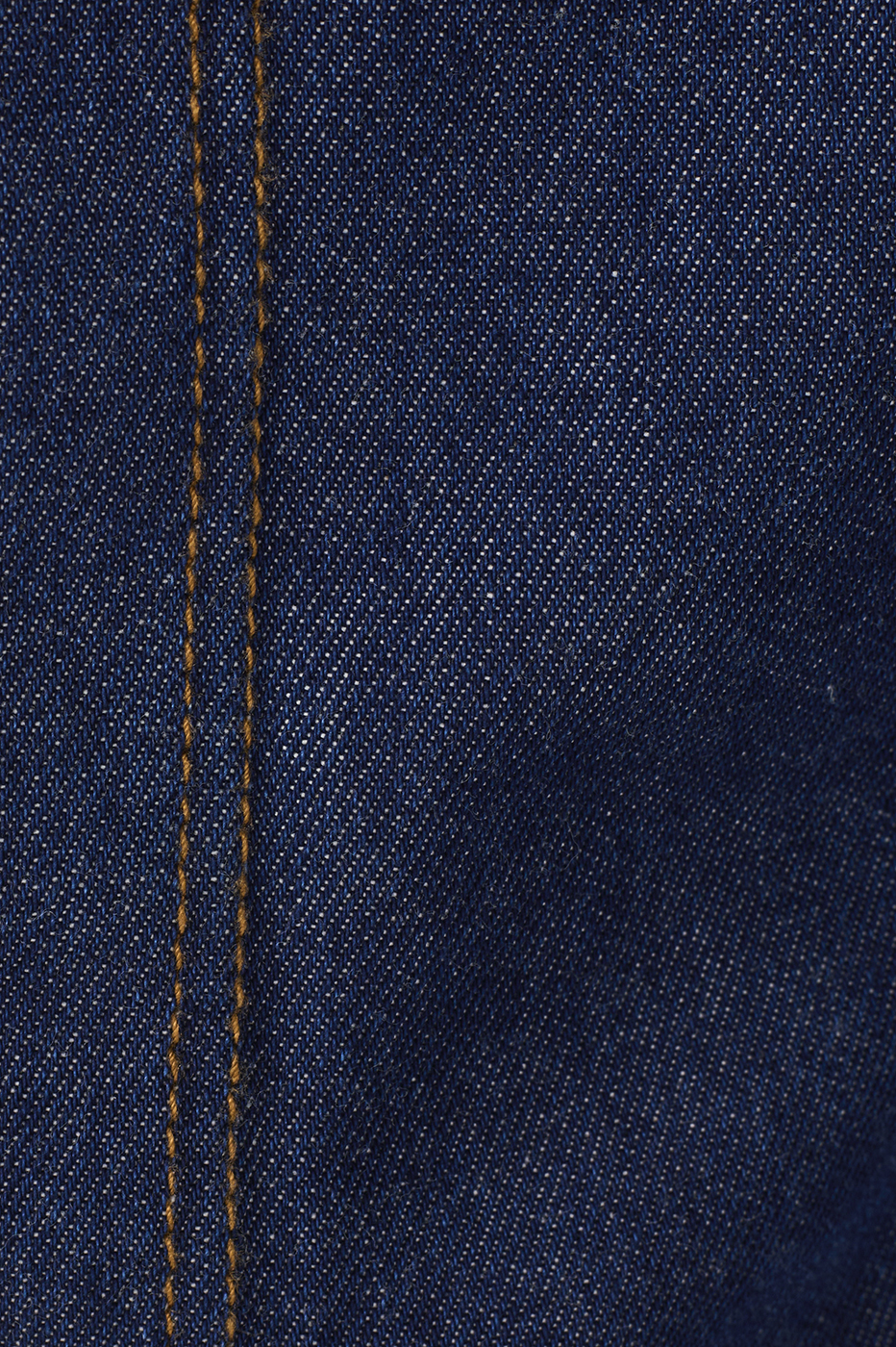 Close-up detail of dark blue denim fabric with orange contrast topstitching