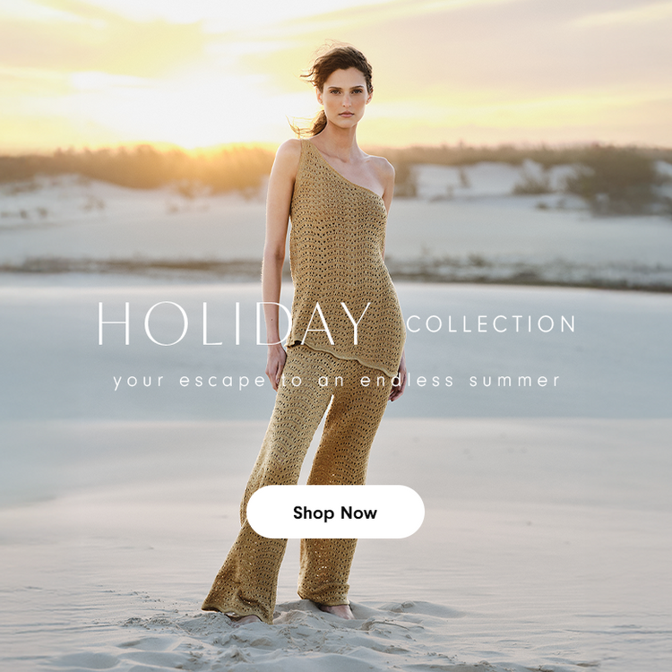 Mobile banner for Dress To Holiday Collection showing model in gold beige crochet knit crop top and wide-leg pants, standing on white sand beach at golden hour sunset. Ocean and sky create dreamy vacation backdrop. White text overlay reads 'HOLIDAY COLLECTION - your escape to an endless summer' with Shop Now call-to-action button. Sustainable resort wear for tropical destinations.