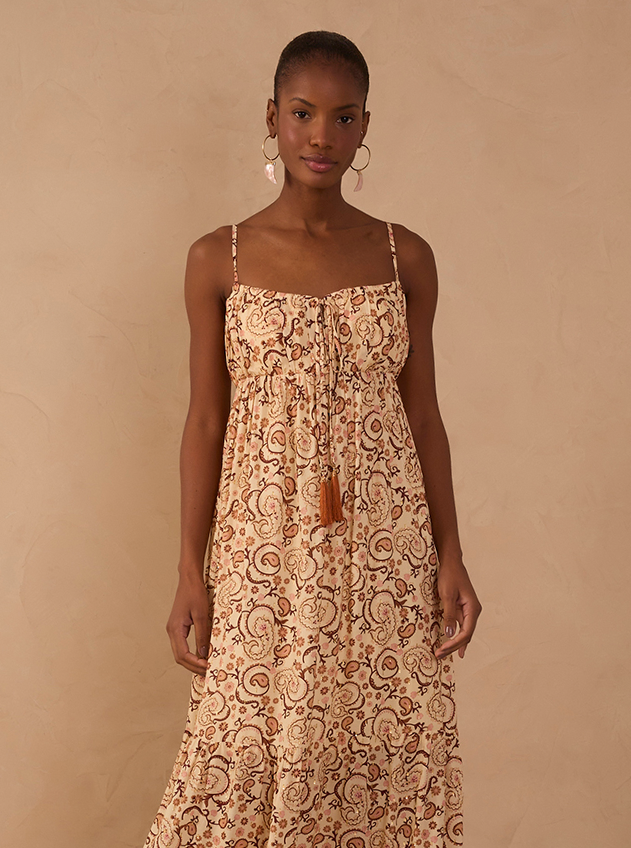 Woman wearing a paisley print maxi dress with thin straps and tassel detail, size L fashion model