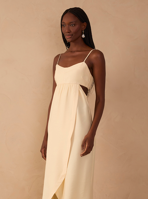 Woman wearing a cream slip dress with thin straps and wrap skirt, size XL fashion model